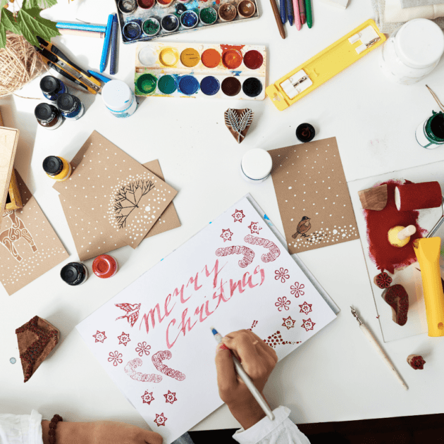 A person making homemade holiday cards