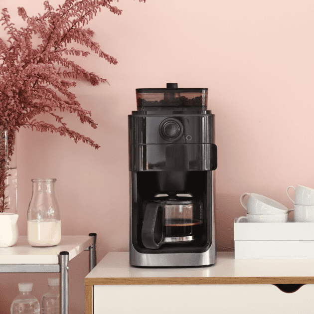 a reusable coffee set up that is organized and has a pink and white theme