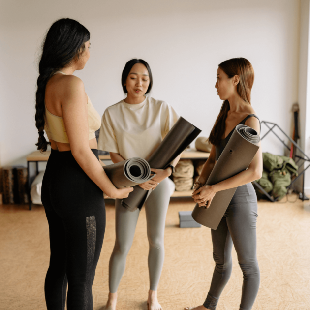 A group of yoga students talking after their yoga class