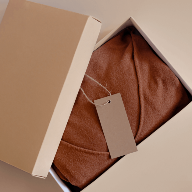 a minimalist sweater in a cardboard box