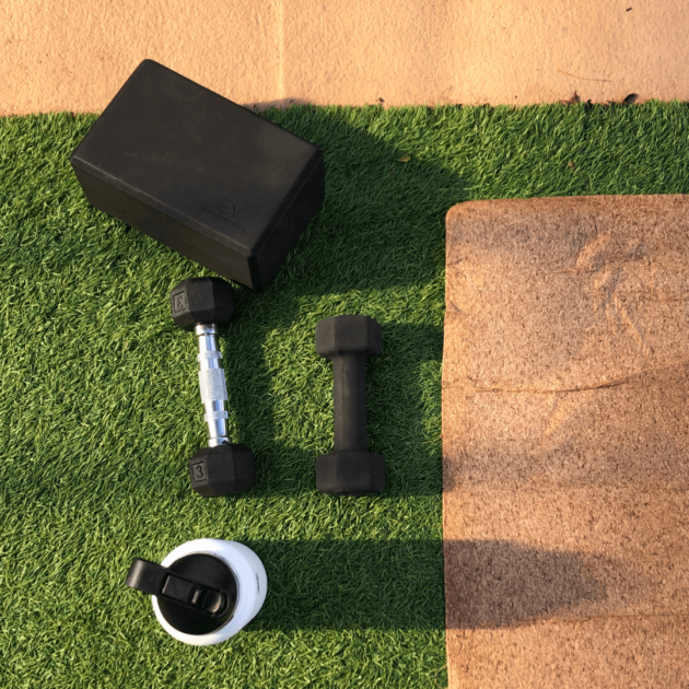 a cork yoga mat, yoga block, weights and reusable waterbottle