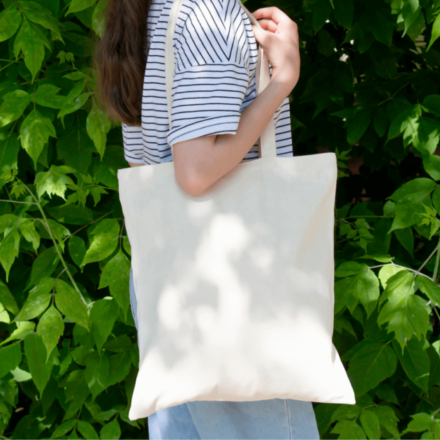 a woman using a reusable tote bag instead of a plastic bag