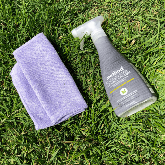 a cleaning spray and microfiber towel to deep clean the outside of your fridge
