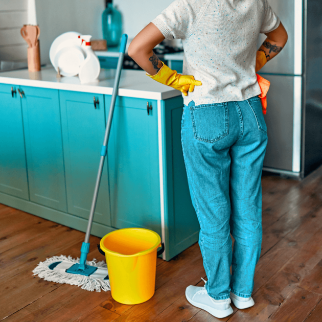 a woman mopping her kitchen floor with a bucket and zero waste mop