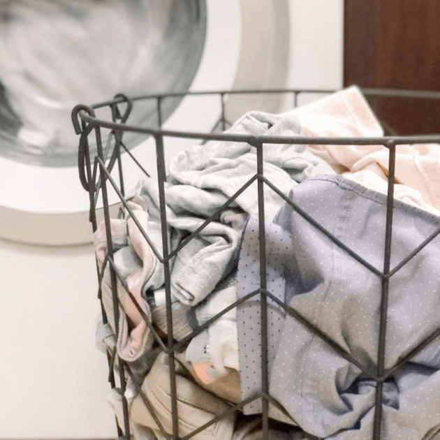 a basket of laundry in a laundry room