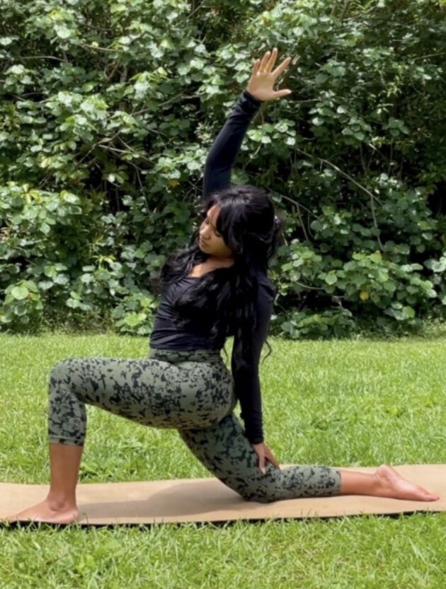 a woman doing a beginner yoga pose who is the creator of sustain life journal yoga