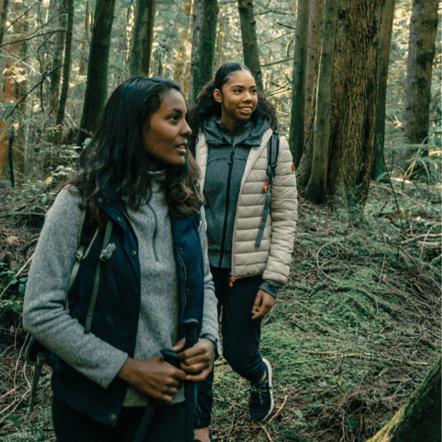 two women hiking in the woods as beginner hikers