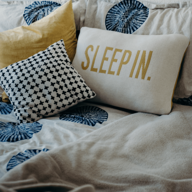 college bedding and decorative pillows with a simple color palette