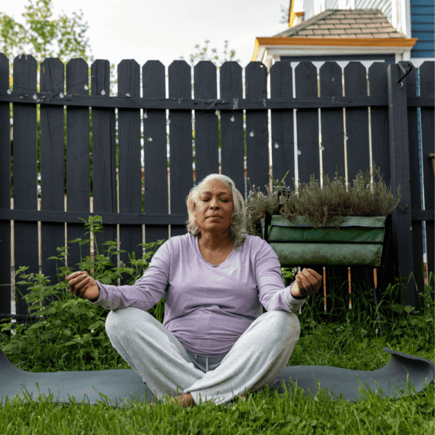 a woman meditating outside