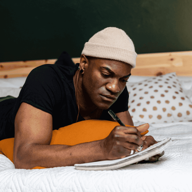 a man journaling about his feelings on his self love journey