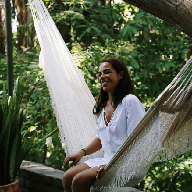 a woman sitting in a cozy hammock