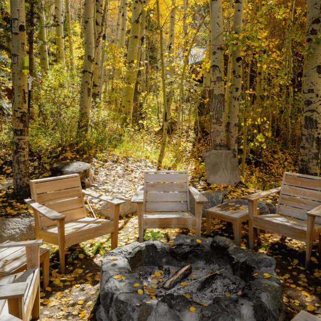 wooden chairs and a backyard fire pit